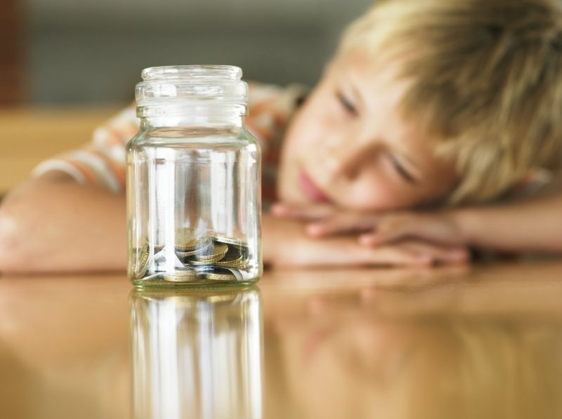 Child with money in jar