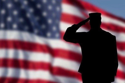 Soldier saluting flag